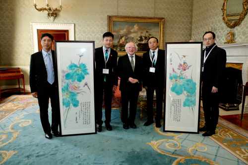 President Higgins as he meets with Chinese delegation being presented with paintings