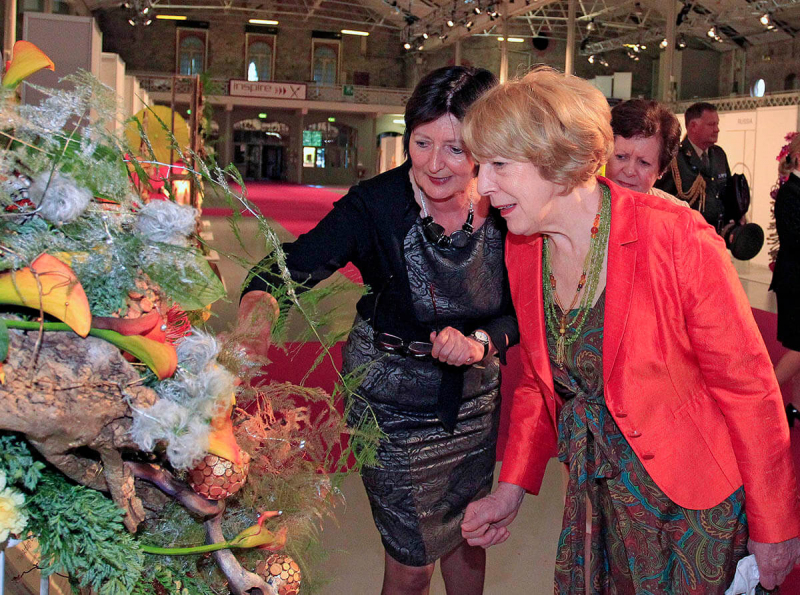 Sabina Higgins is shown the Irish exhibit by Mary O'Brien, designer of the creation.